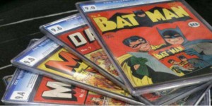 Four collectible comics spread out with Batman comic on top