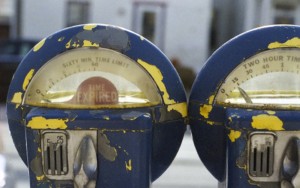 Two parking meters side by side. One expired, the other about to expire.